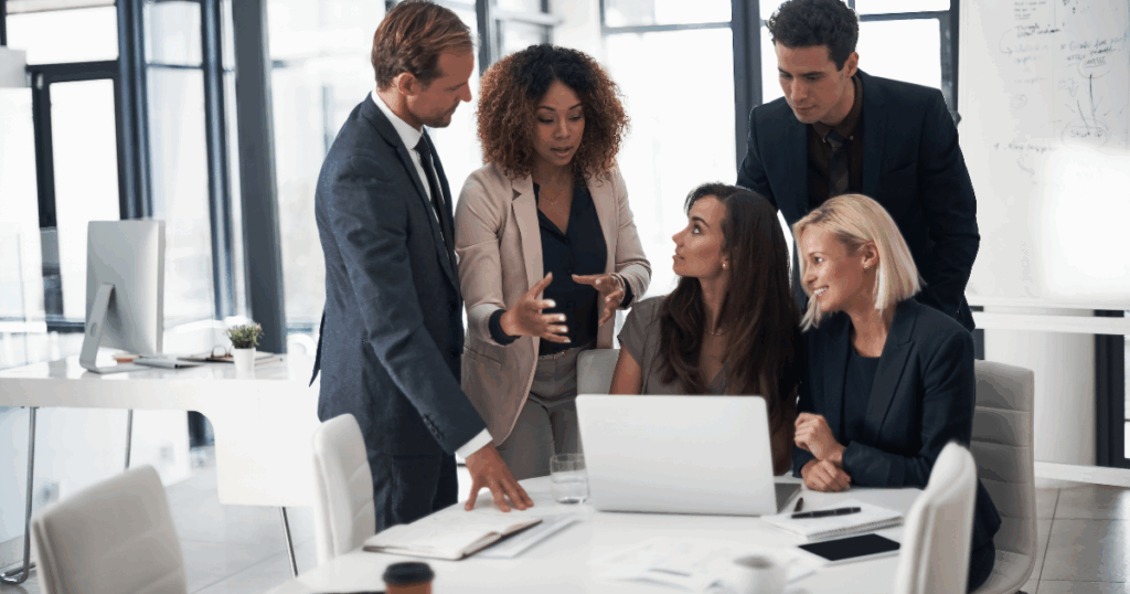 7 Signs It’s Time to Restructure Your Business Entity 1 Business team discussing strategic entity to restructure and options to reduce taxes and protect assets.