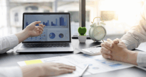 Business professionals reviewing financial projections and planning tools on a laptop for business growth