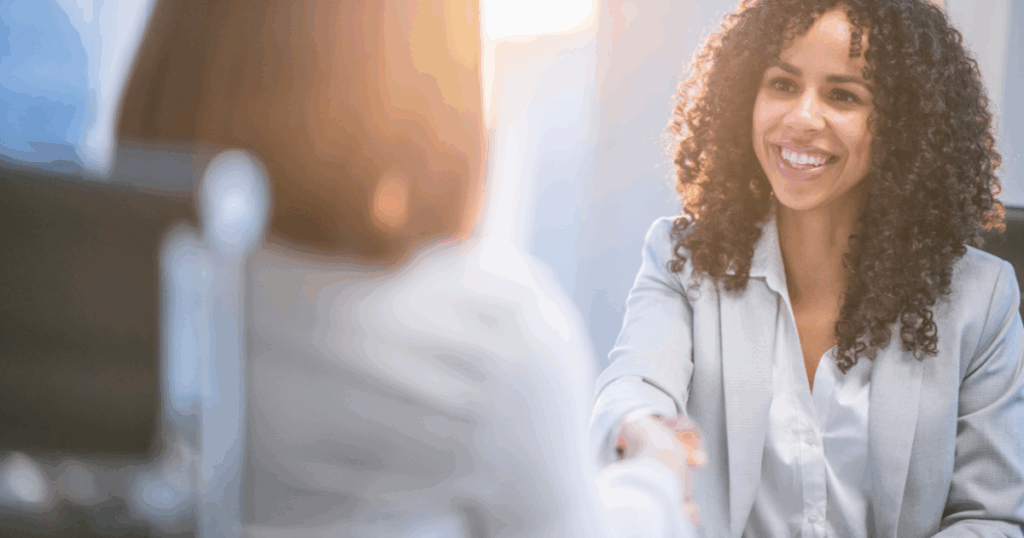Smiling professional shaking hands with a client, symbolizing trusted CPA support and compassionate financial guidance at Meinershagen & Co.