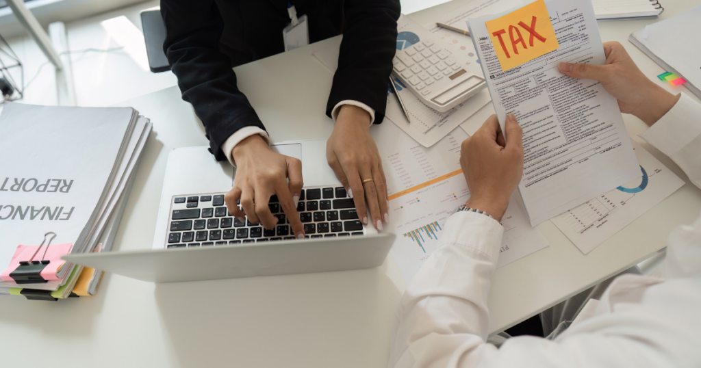 Accountant calculating estimated payments and developing a tax plan that minimizes penalties using detailed financial reports.