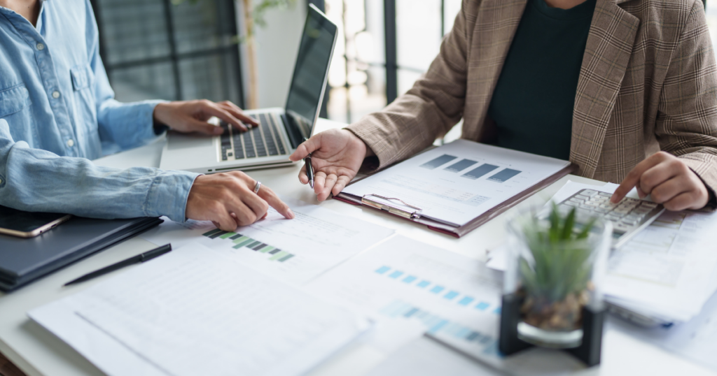 Client and CPA discussing proactive tax planning documents, trust filing needs, and business entity compliance during a strategy meeting.